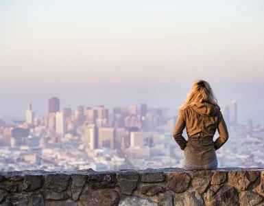 Une jeune femme regardant la ville depuis une allée sur une falaise