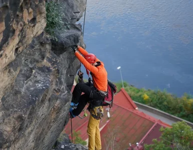 Un homme qui escalade une montagne au bord de la mer